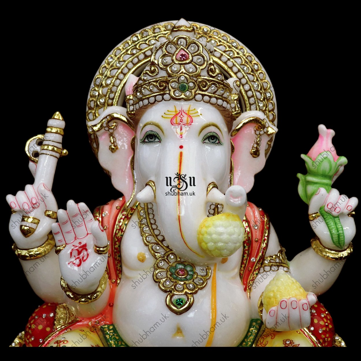 Elegant white marble statue of Lord Ganesh on a carved wooden stand
